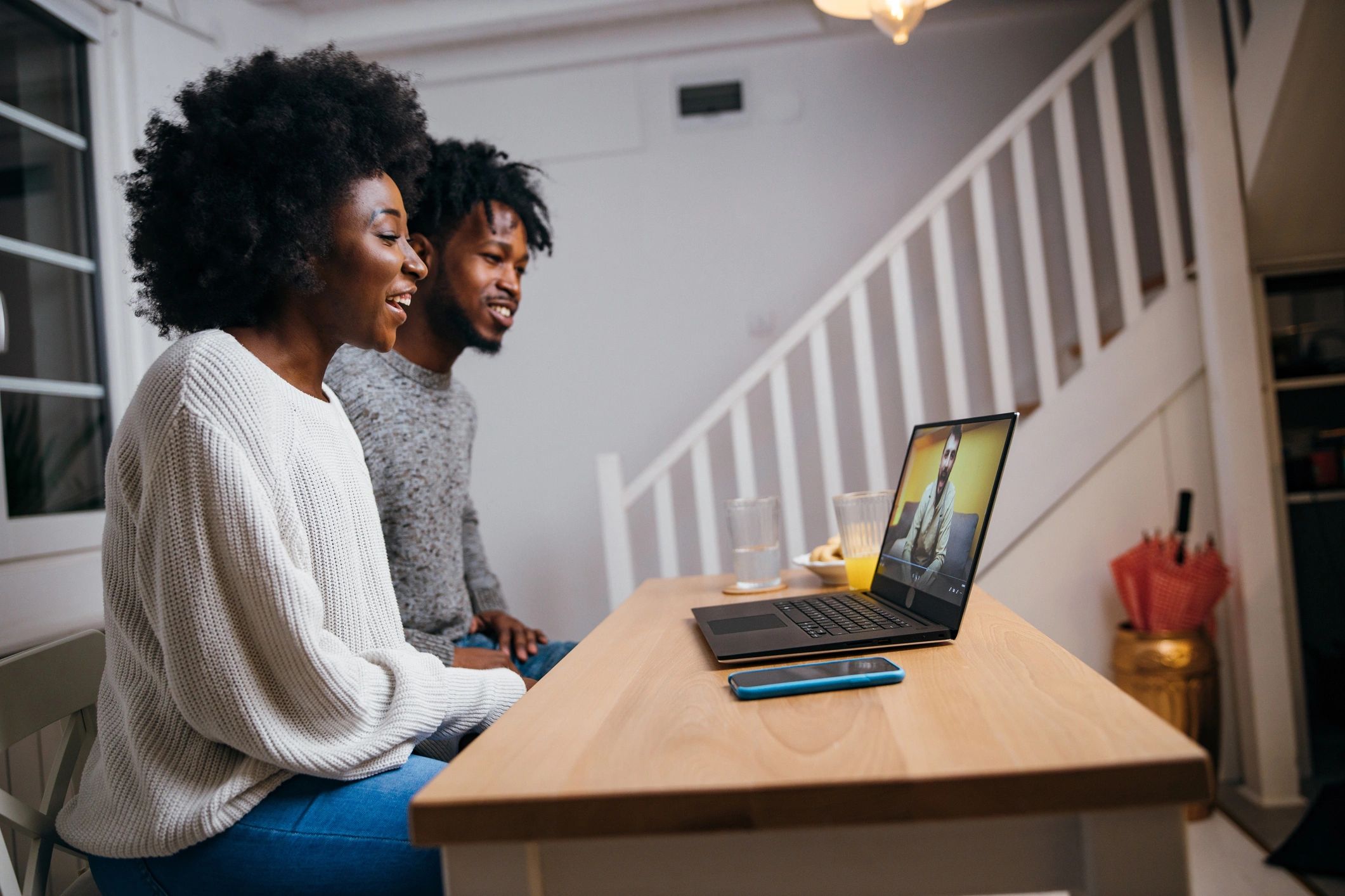 Couple using a laptop to research household decisions