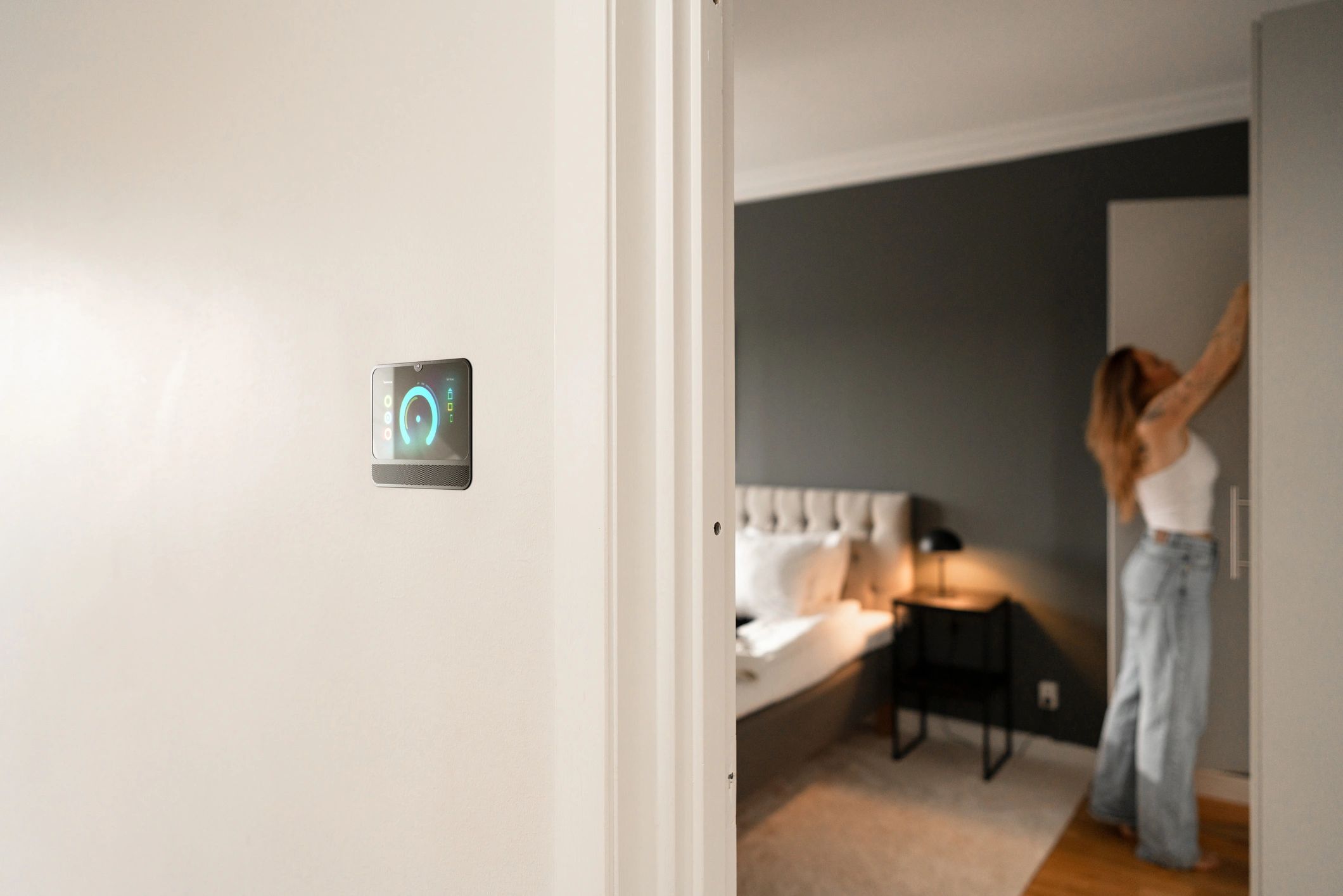 Homeowner reviewing home energy information near a smart thermostat